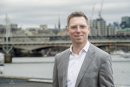 Rob Blackie pictured in a grey blazer with a white shirt