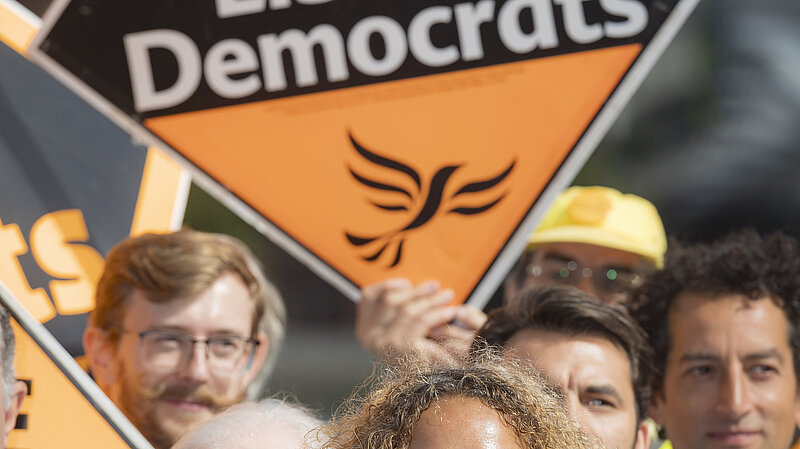 Liberal Democrat activists pictured with signs