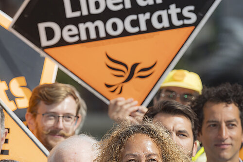 Liberal Democrat campaigners pictured with signs