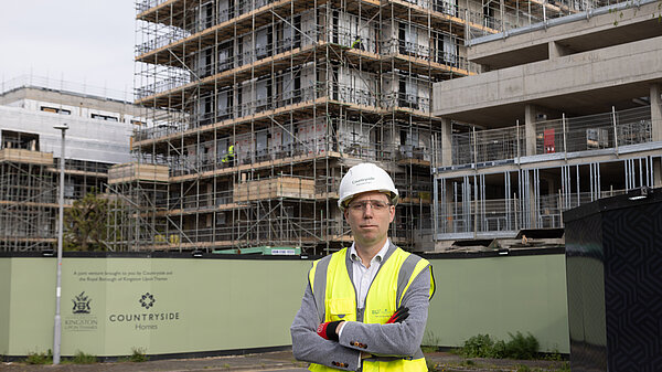 Rob Blackie pictured in a hi-vis and hardhat in front of a construction site