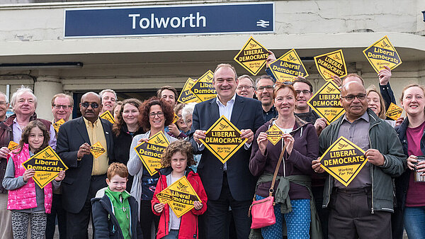 Ed Davey with a large group of activists in front of train station