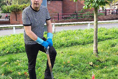 Cllr Gary Busuttil planting a tree.
