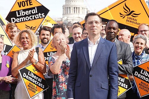 Rob Blackie pictured with Liberal Democrat activists holding signs