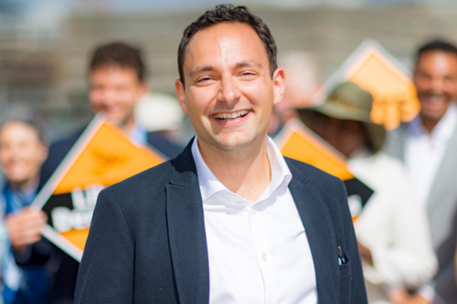 Blaise standing in front of a crowd of Liberal Democrat campaigners