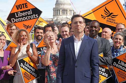 Rob Blackie pictured with Liberal Democrat activists holding signs